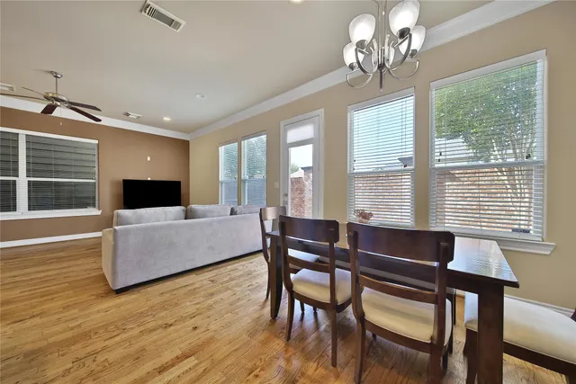 a living room with furniture wooden floor and a chandelier