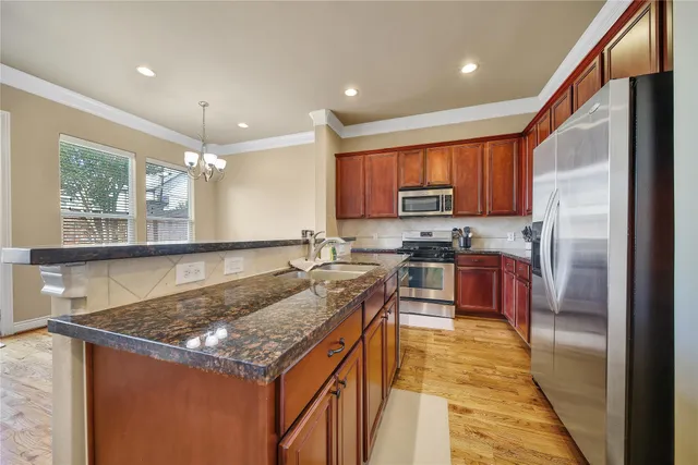 a kitchen with stainless steel appliances granite countertop a stove sink and cabinets