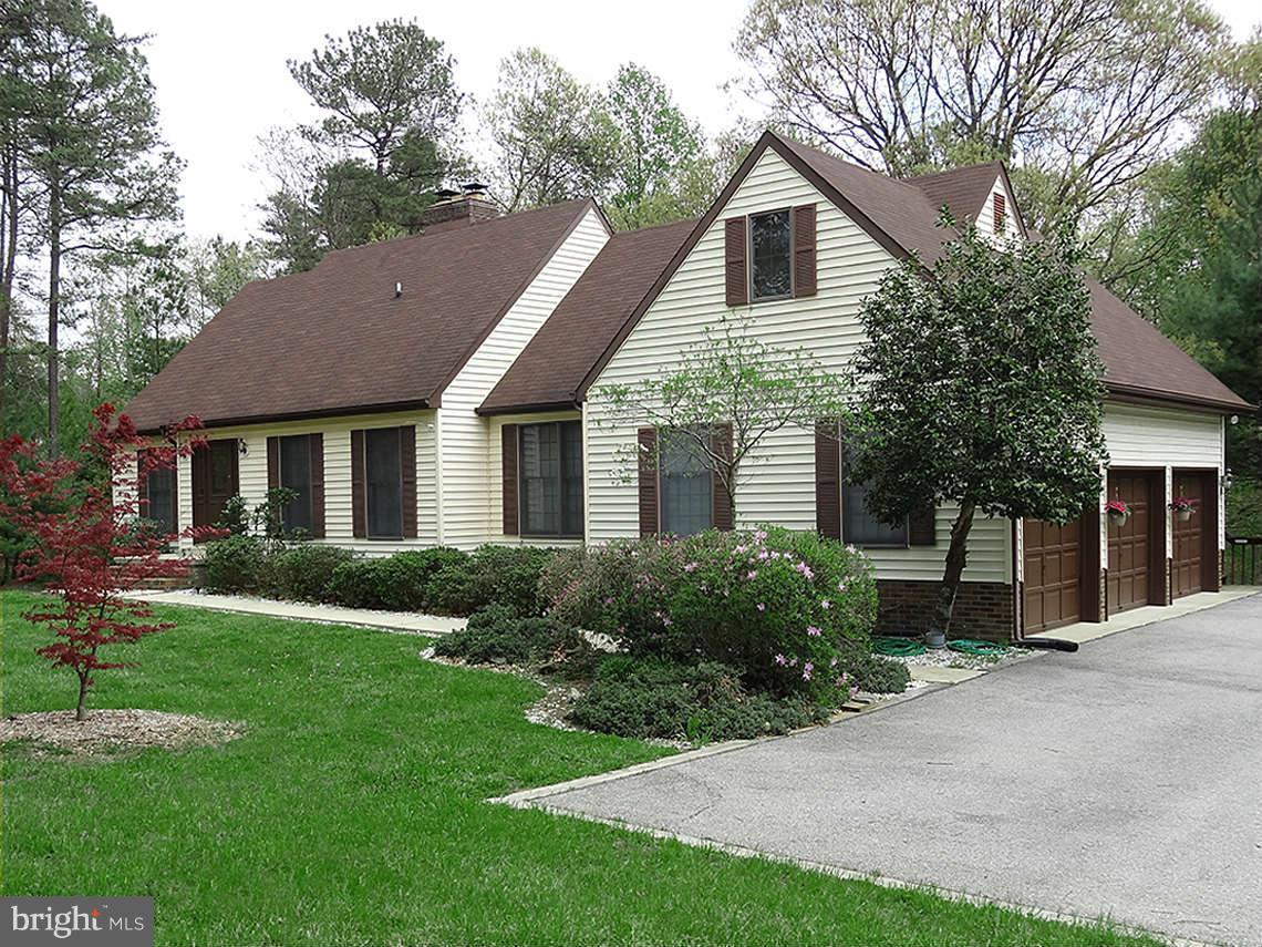 1200 Parran Road St. Leonard, MD 20685 - Photo 1 of 29 a front view of a house with a yard and garage