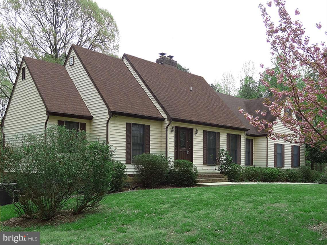 1200 Parran Road St. Leonard, MD 20685 - Photo 2 of 29 a front view of a house with a garden