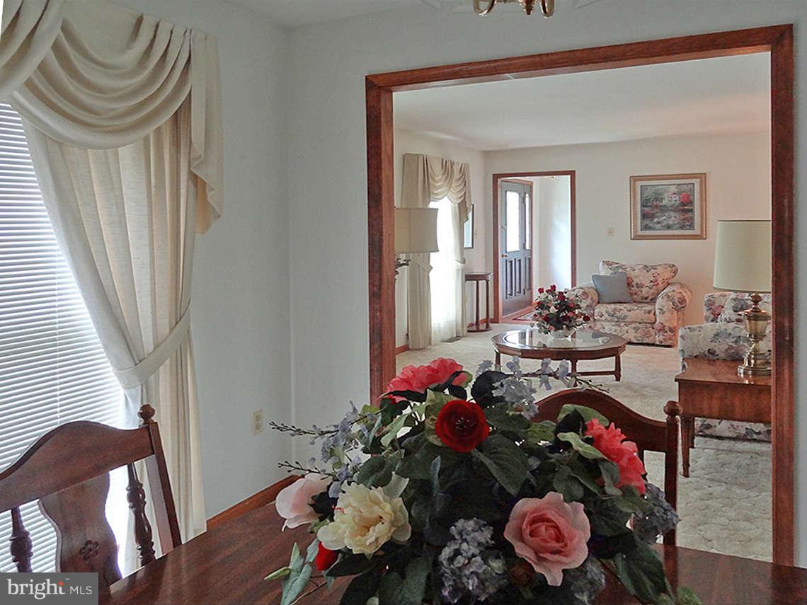 1200 Parran Road St. Leonard, MD 20685 - Photo 16 of 29 a living room with furniture and a chandelier