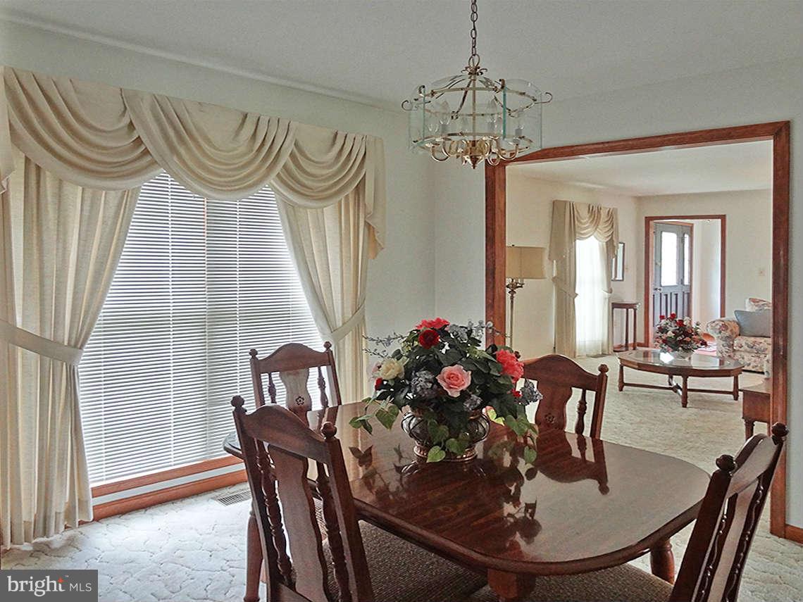 1200 Parran Road St. Leonard, MD 20685 - Photo 17 of 29 a view of a dining room with furniture and wooden floor