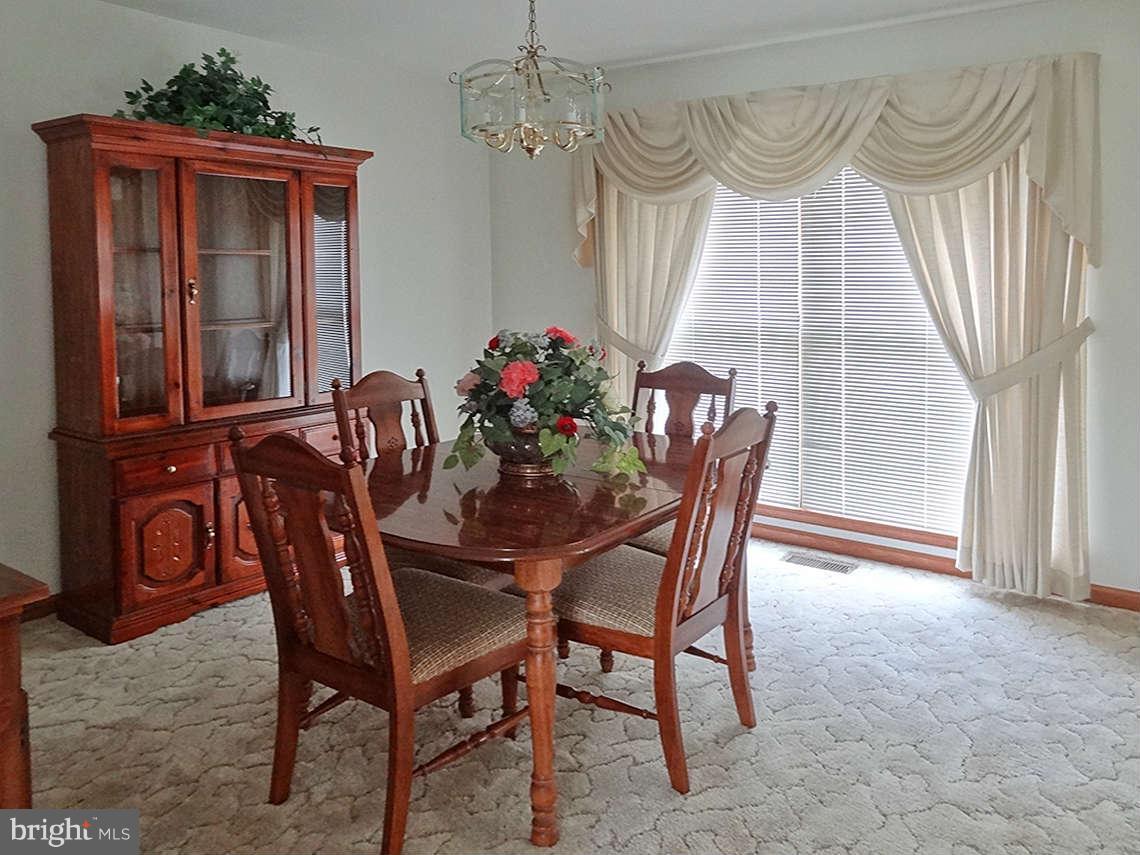 1200 Parran Road St. Leonard, MD 20685 - Photo 18 of 29 a view of a dining room with furniture window and wooden floor