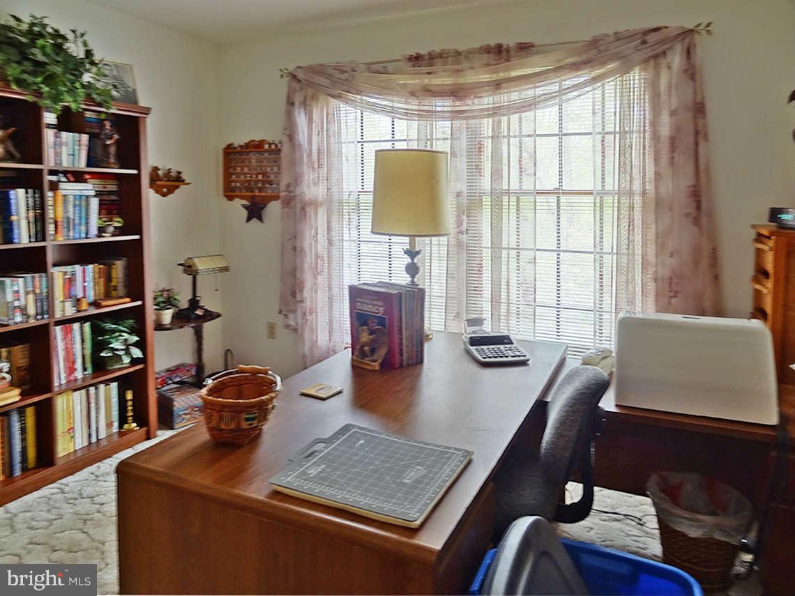 1200 Parran Road St. Leonard, MD 20685 - Photo 22 of 29 a view of a workspace with furniture and a window