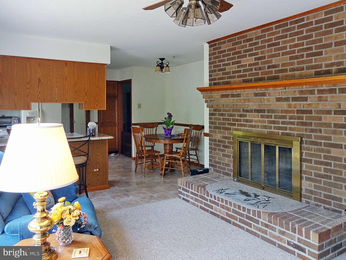 1200 Parran Road St. Leonard, MD 20685 - Photo 24 of 29 a living room with furniture and a fireplace