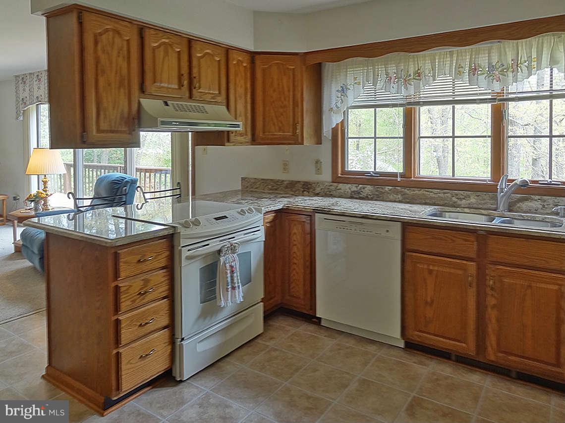 1200 Parran Road St. Leonard, MD 20685 - Photo 25 of 29 a kitchen with stainless steel appliances granite countertop a sink stove and cabinets