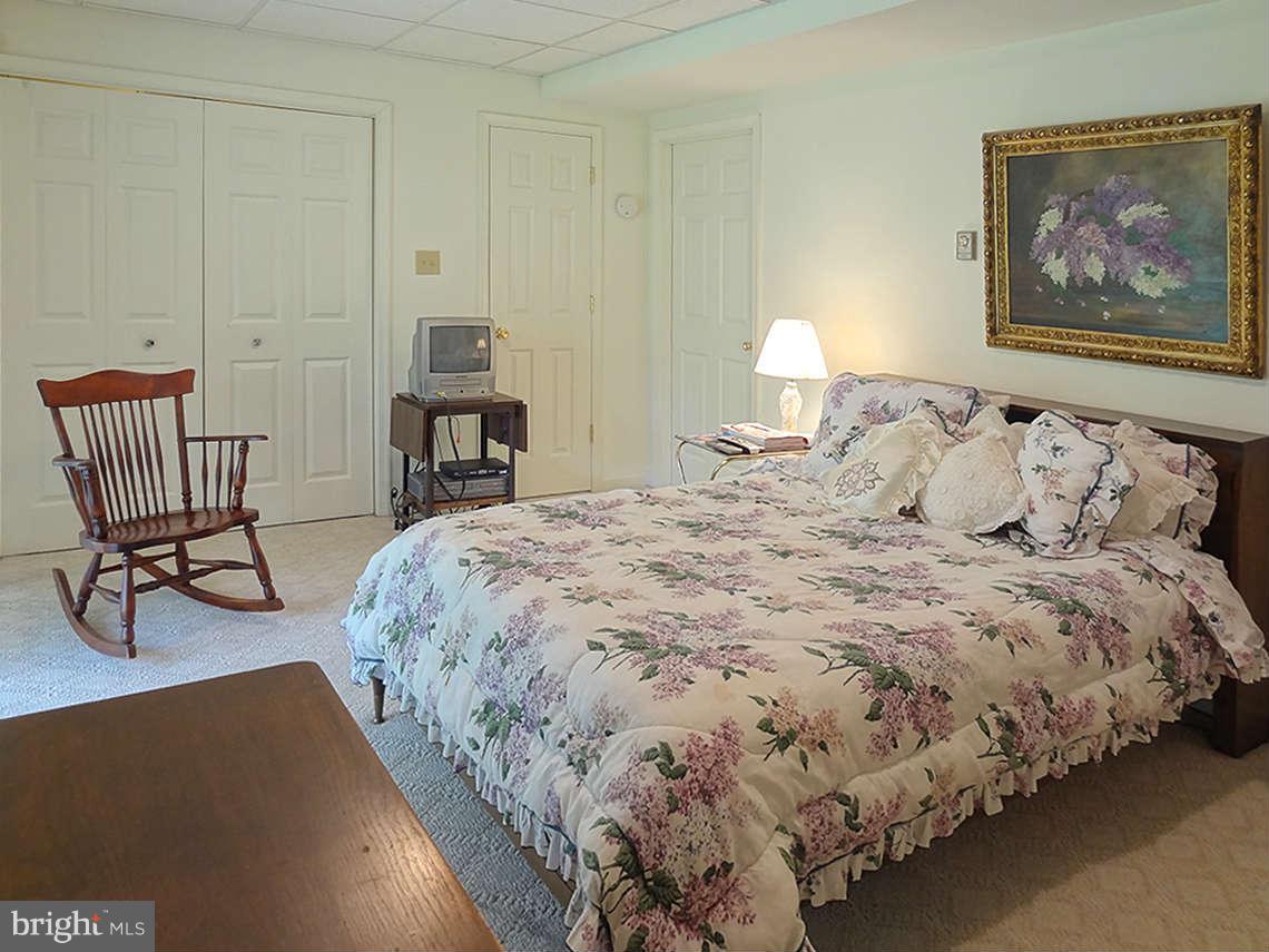 1200 Parran Road St. Leonard, MD 20685 - Photo 27 of 29 a bedroom with bed and chair
