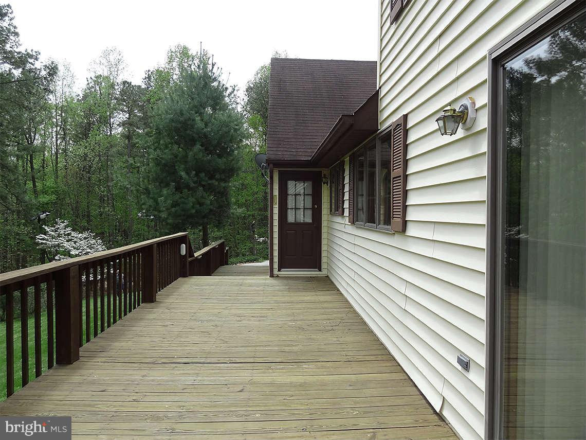 1200 Parran Road St. Leonard, MD 20685 - Photo 9 of 29 a view of a house with a deck
