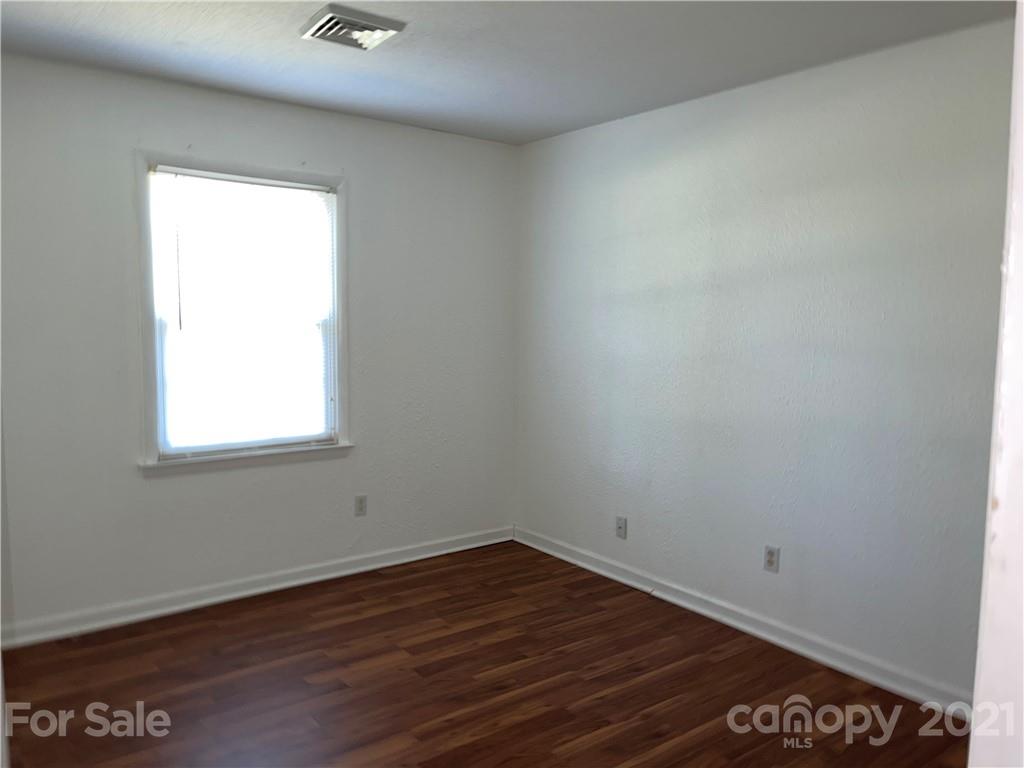 126 Sparrow Road Statesville, NC 28625 - Photo 12 of 29 an empty room with wooden floor and windows