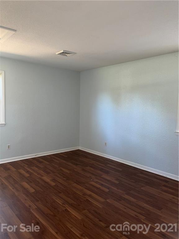 126 Sparrow Road Statesville, NC 28625 - Photo 16 of 29 a view of an empty room with wooden floor