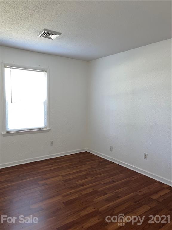 126 Sparrow Road Statesville, NC 28625 - Photo 17 of 29 an empty room with wooden floor and windows