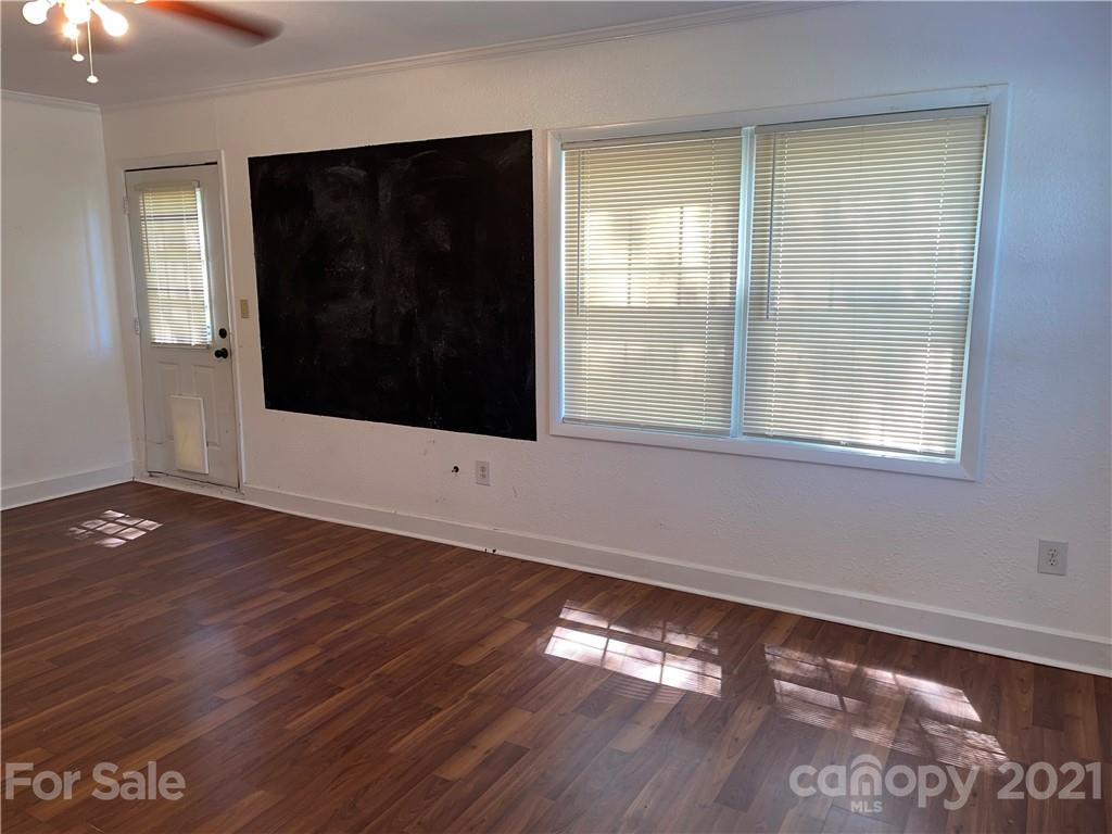 126 Sparrow Road Statesville, NC 28625 - Photo 18 of 29 a view of an empty room with wooden floor and a window