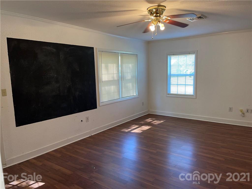 126 Sparrow Road Statesville, NC 28625 - Photo 19 of 29 a view of an empty room with wooden floor and a window
