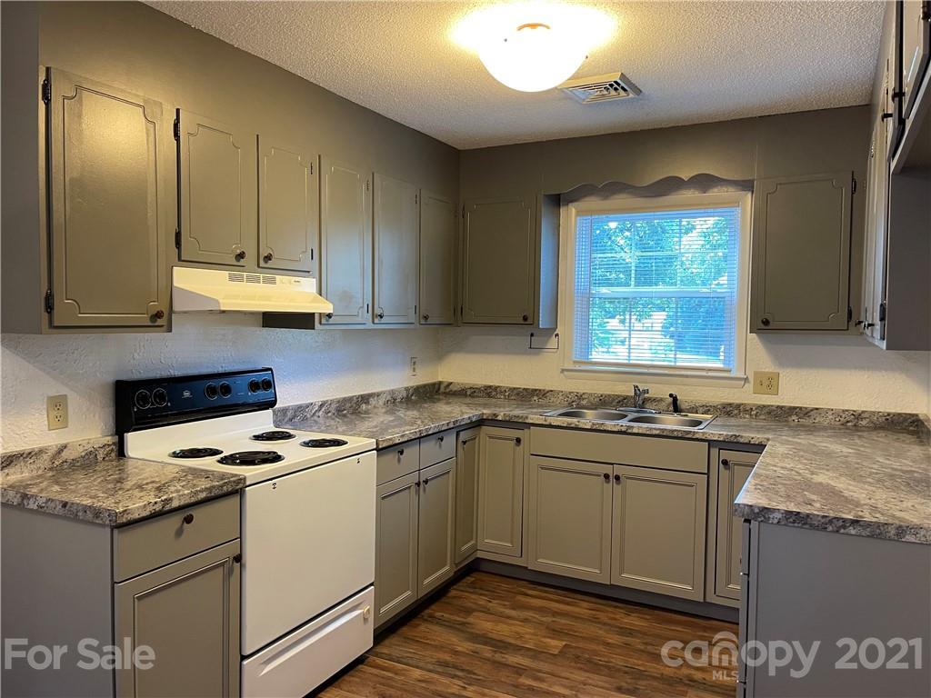 126 Sparrow Road Statesville, NC 28625 - Photo 3 of 29 a kitchen with stainless steel appliances granite countertop a sink stove and cabinets