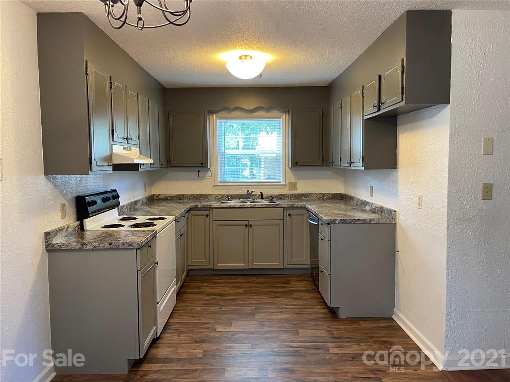 126 Sparrow Road Statesville, NC 28625 - Photo 4 of 29 a kitchen with a sink stove and cabinets