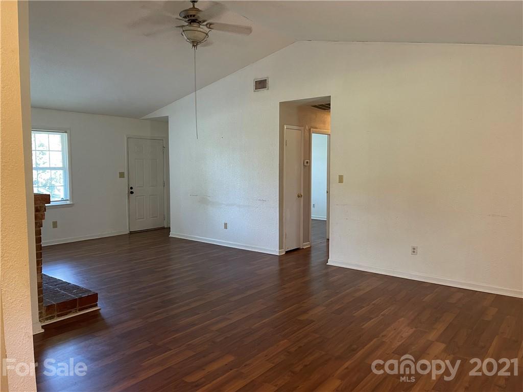 126 Sparrow Road Statesville, NC 28625 - Photo 7 of 29 a view of a room with wooden floor and a ceiling fan