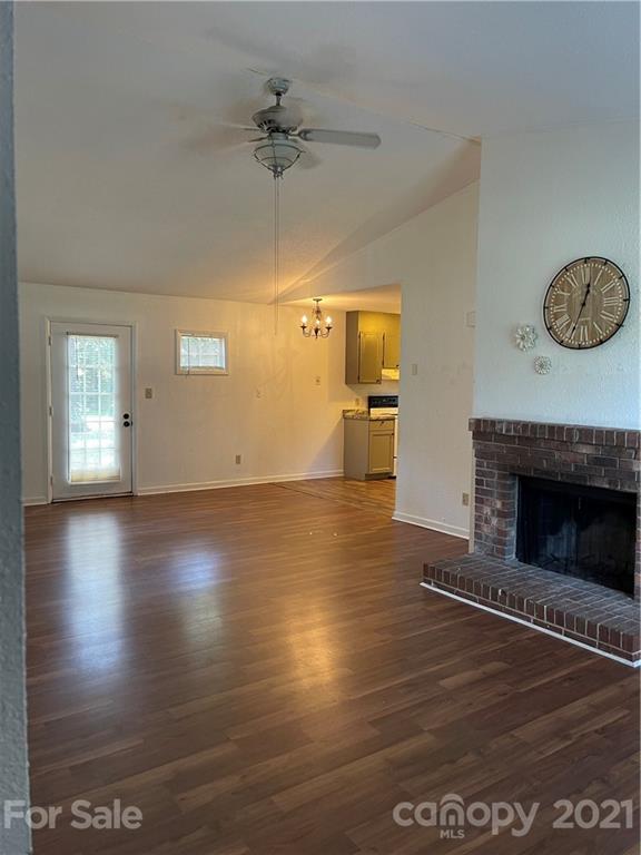 126 Sparrow Road Statesville, NC 28625 - Photo 9 of 29 a view of an empty room with a fireplace and wooden floor