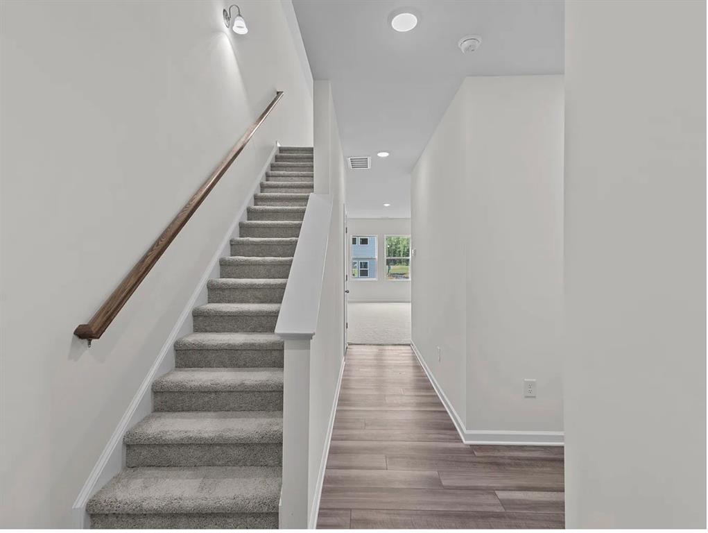 2012 Prairie Lane Melissa, TX 75454 - Photo 16 of 24 a view of staircase with wooden floor and white walls