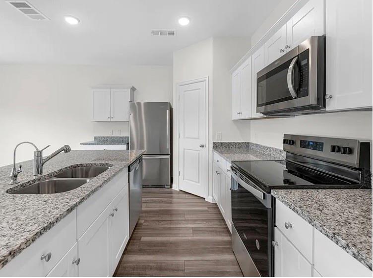 2012 Prairie Lane Melissa, TX 75454 - Photo 20 of 24 a kitchen with stainless steel appliances granite countertop a sink stove and refrigerator