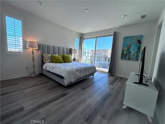 a bedroom with a bed and large window