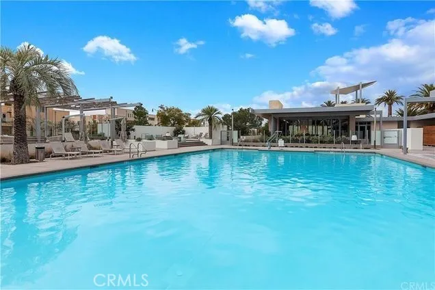 a view of swimming pool with outdoor seating and city view