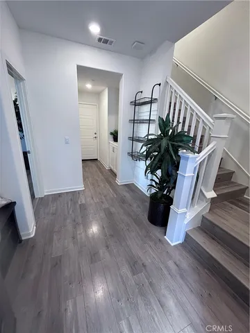 a view of an entryway with wooden floor
