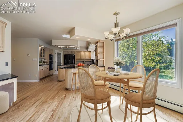 a view of a dining room with furniture window and wooden floor