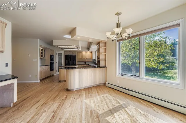 a view of a living room and kitchen with furniture wooden floor