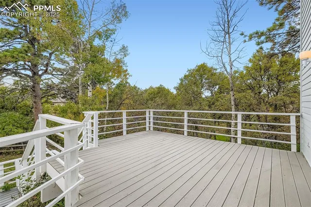 a view of a deck with wooden floor and fence