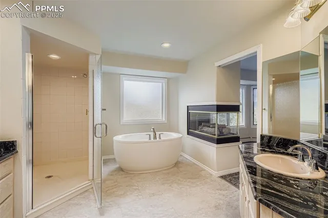 a spacious bathroom with a bathtub sink and mirror
