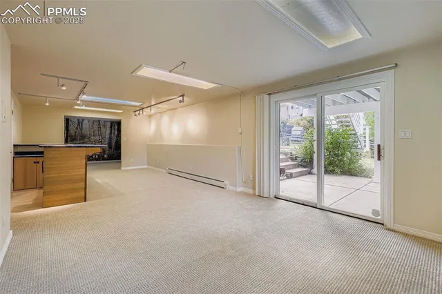 an empty room with a cabinet and mirrors