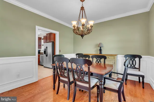 a view of a dining room with furniture wooden floor and chandelier
