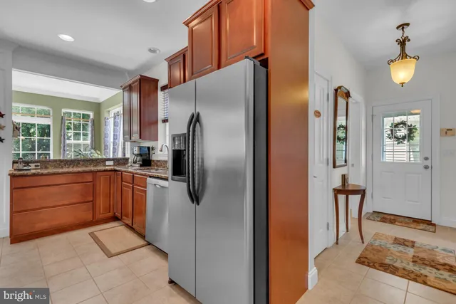a kitchen with stainless steel appliances granite countertop a refrigerator and a sink