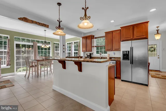 a kitchen with stainless steel appliances granite countertop a stove and a refrigerator