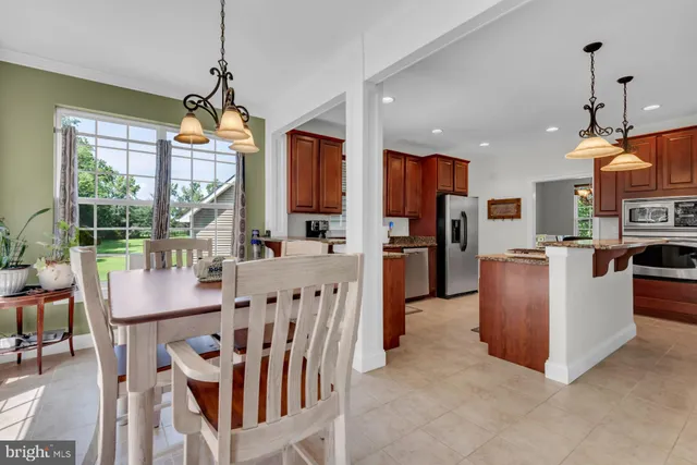 a view of kitchen with furniture and a chandelier