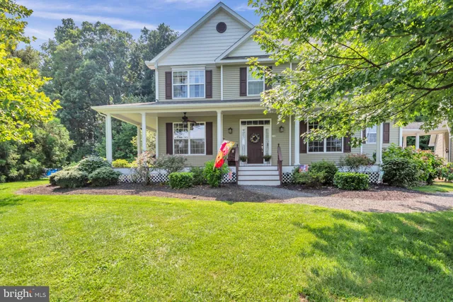 a front view of a house with a yard and trees