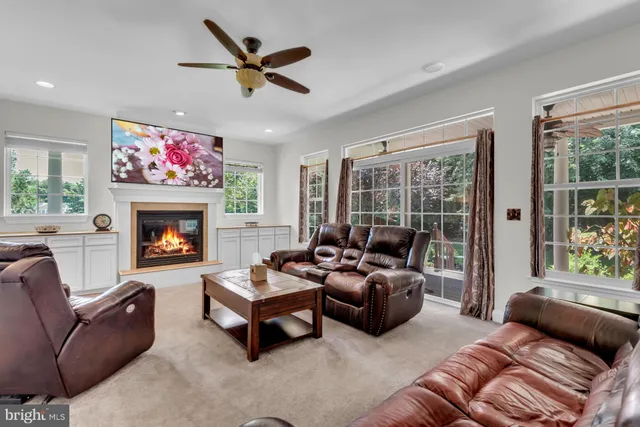a living room with furniture a fireplace and a flat screen tv