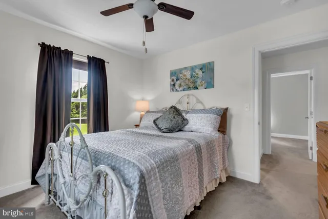 a bedroom with a bed and a large mirror