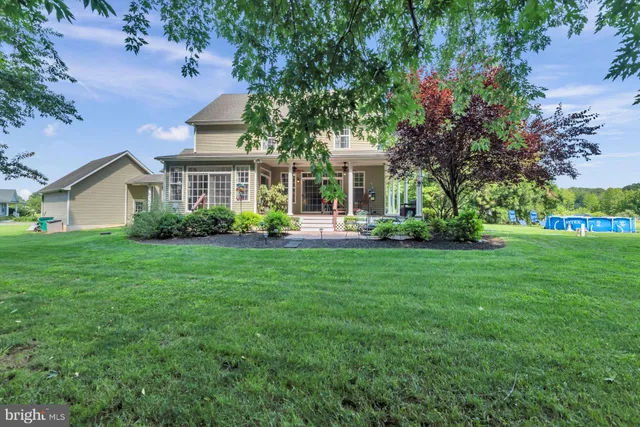a front view of a house with a yard and potted plants