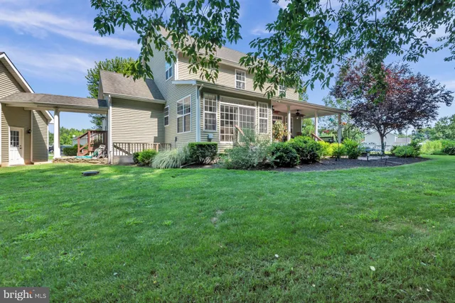 a front view of a house with a yard and trees
