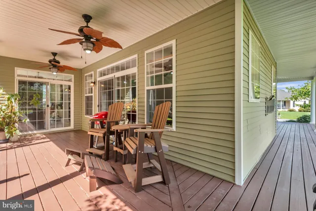 a view of a patio with a dining table chairs and a yard