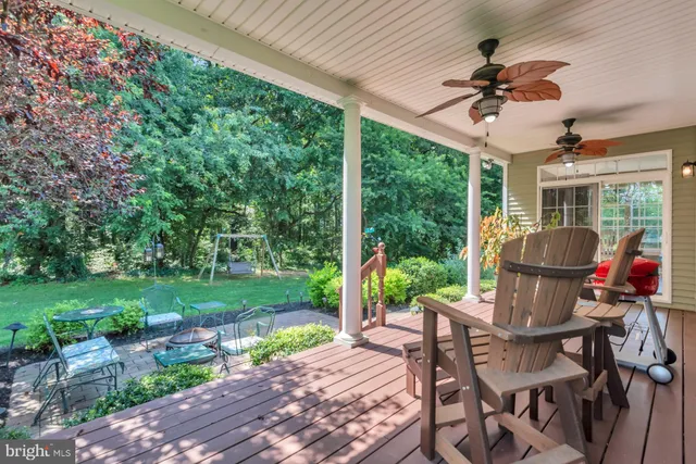a view of a patio with table and chairs potted plants with wooden floor