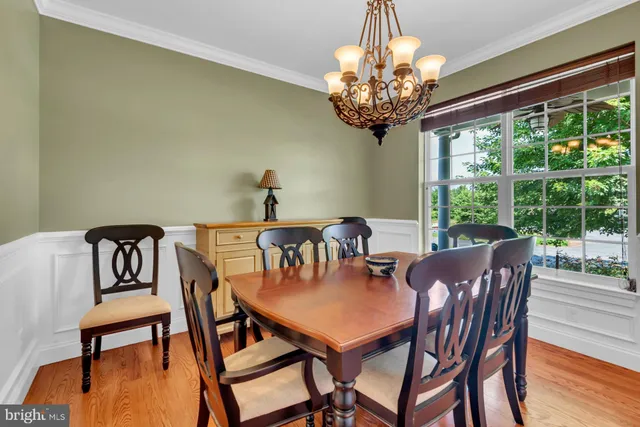 a view of a dining room with furniture wooden floor and chandelier