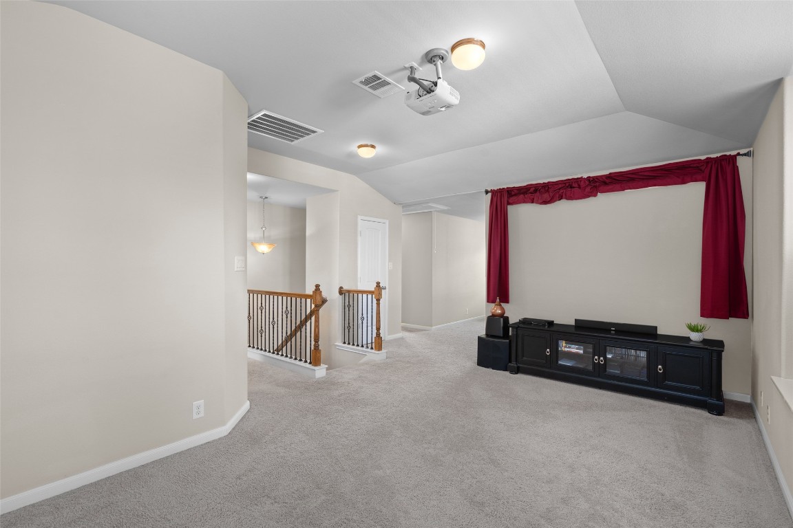 8540 White Ibis Drive Austin, TX 78729 - Photo 18 of 39 a room with gym equipment and a flat screen tv