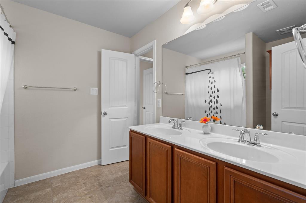 8540 White Ibis Drive Austin, TX 78729 - Photo 23 of 39 a bathroom with a sink and a mirror