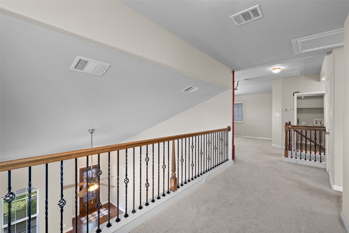 8540 White Ibis Drive Austin, TX 78729 - Photo 27 of 39 a view of hallway with chandelier