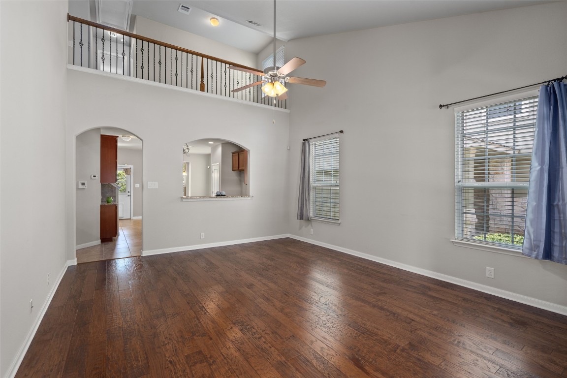 8540 White Ibis Drive Austin, TX 78729 - Photo 4 of 39 wooden floor in an empty room with a window