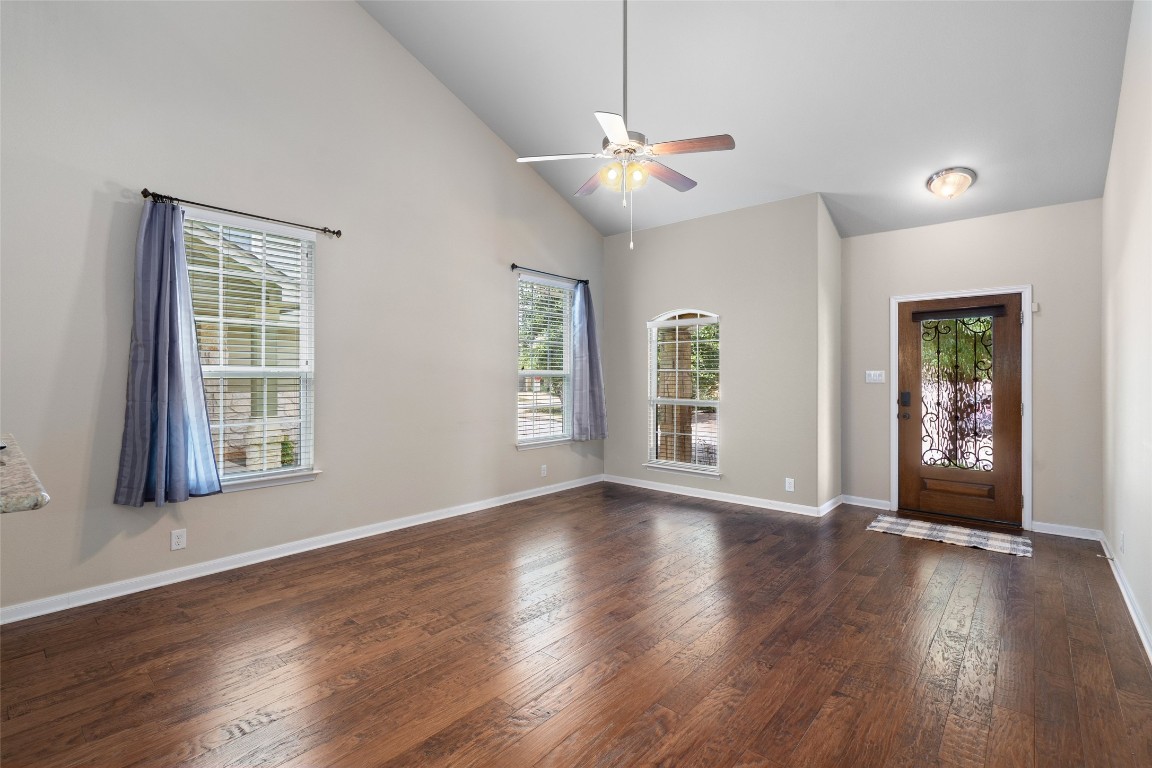 8540 White Ibis Drive Austin, TX 78729 - Photo 5 of 39 a view of an empty room with wooden floor and a window