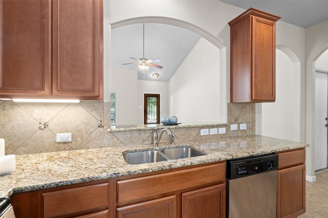 8540 White Ibis Drive Austin, TX 78729 - Photo 8 of 39 a kitchen with granite countertop stainless steel appliances a sink and cabinets