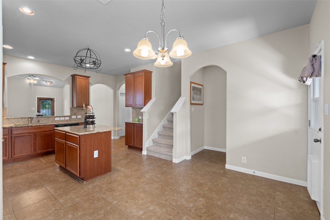 8540 White Ibis Drive Austin, TX 78729 - Photo 10 of 39 a room with chandelier fan and wooden floor